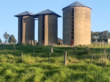 Three old concrete farm silos.